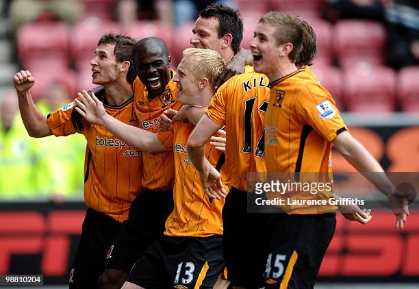 Mark Cullen of Hull City is mobbed after scoring the second goal during the Barclays Premier League match between Wigan Athletic and Hull City at JJB...