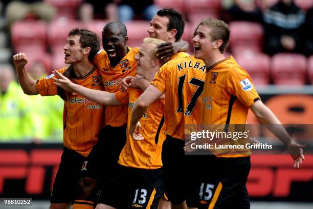 Mark Cullen of Hull City is mobbed after scoring the second goal during the Barclays Premier League match between Wigan Athletic and Hull City at JJB...