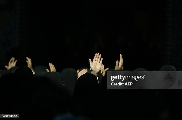 Shiite Muslim women hold their hands up during the Ashura tradition in the holy city of Karbala,110kms on December 24, 2009. Ashura is a Shiite...