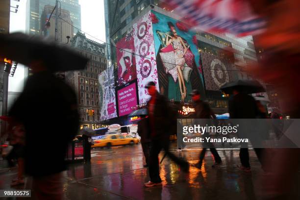 Pedestrians walk past the corner of 42nd Street and 7th Avenue in Times Square May 3, 2010 in New York City. The area resumed normal operations, with...