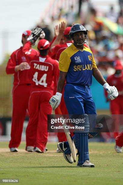 Kumar Sangakkara of Sri Lanka leaves the field after being dismissed as Zimbabwe celebrate during the ICC T20 World Cup Group B match between Sri...