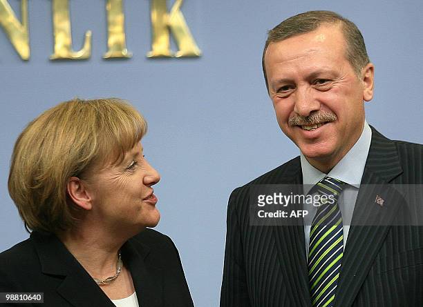 German Chancellor Angela Merkel and Turkey's Prime Minister Tayyip Erdogan speak after arriving for a press conference in Ankara on March 29, 2010....