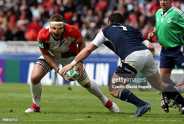 Imanol Harinordoquy of Biarritz, wearing a nose protector, takes on David Wallace during the Heineken Cup semi final match between Biarritz Olympique...