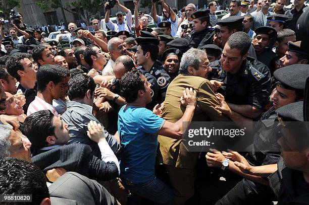 Protester scuffles with police during a demonstration near the parliament building in downtown Cairo on May 3, 2010 to demand fair elections as well...