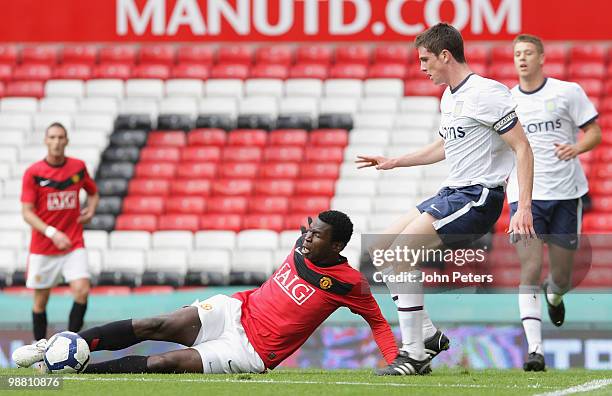 Mame Biram Diouf of Manchester United clashes with Ciaran Clark of Aston Villa during the Barclays Premier Reserve League Play-Off match between...