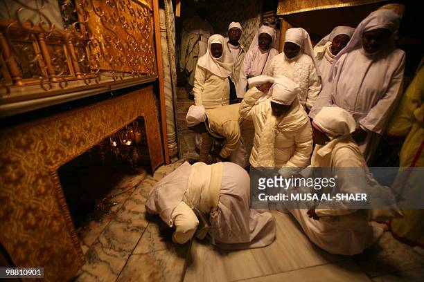Nigerian Christian pilgrims pray at the Grotto in the Church of the Nativity, believed to be the traditional birthplace of Jesus Christ, in the West...
