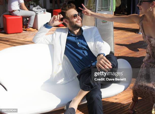 Douglas Booth and Bel Powley attend the Audi Polo Challenge at Coworth Park Polo Club on June 30, 2018 in Ascot, England.