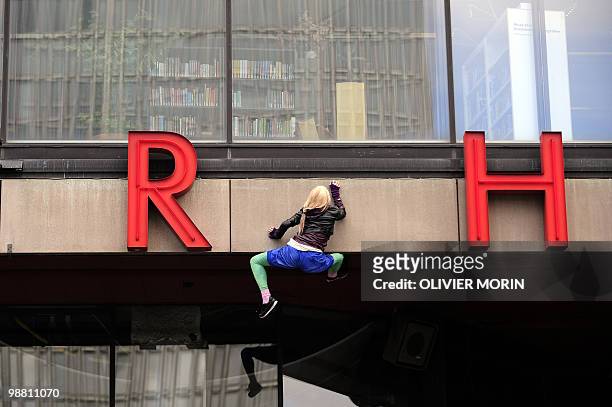 An art installation shows a life-size dummy climbing the front of the Cultural Center of Stockholm on May 3, 2010 ahead of an exhibition on Art...
