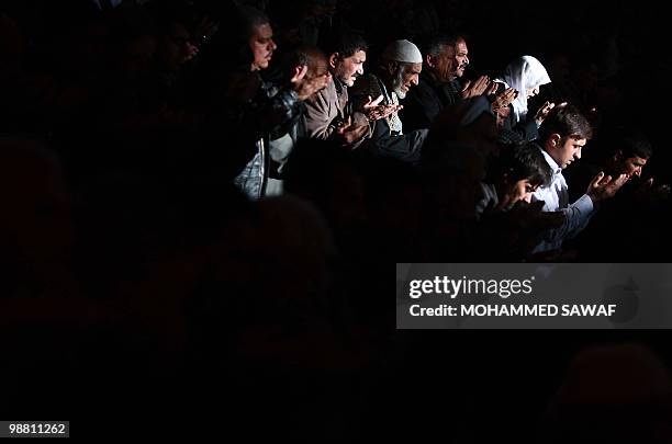 Iraqi Shiite Muslims pray at a mosque to mark Ashura in the Iraqi shrine city of Karbala on December 18, 2009. Ashura is a Shiite religious event...