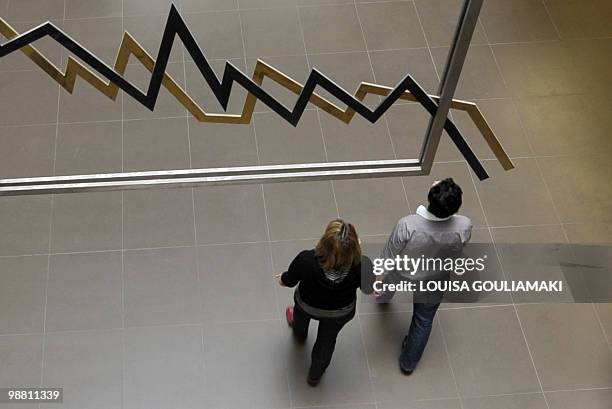 Employees walk in Athens stock exchange on April 28, 2010. Greece acted to stop speculators operating on the Athens stock exchange as the interest...