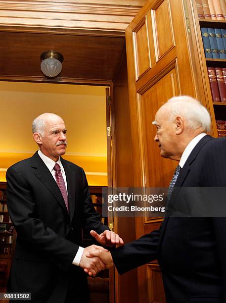 George Papandreou, Greece's prime minister, left, arrives for a meeting with Karolos Papoulias, Greece's president, at the presidential palace in...