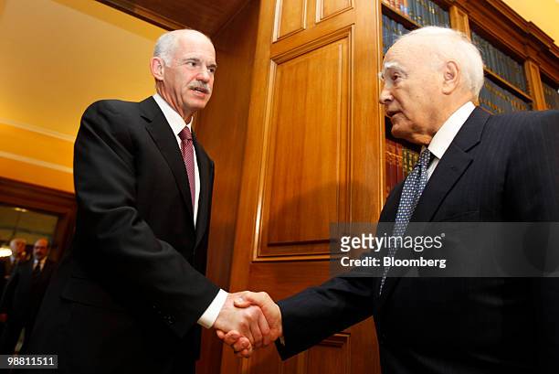 George Papandreou, Greece's prime minister, left, arrives for a meeting with Karolos Papoulias, Greece's president, at the presidential palace in...