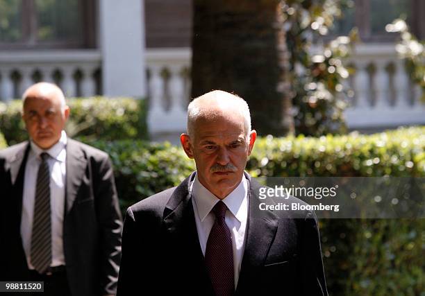 George Papandreou, Greece's prime minister, center, leaves the presidential palace following a meeting with Karolos Papoulias, Greece's president, in...
