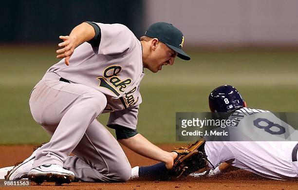 Shortstop Cliff Pennington of the Oakland Athletics waits to tag the baserunner Jason Bartlett of the Tampa Bay Rays on a steal attempt during the...
