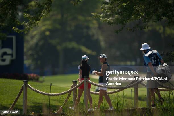 Of America Vice President Suzy Whaley talks with Pannarat Thanapolboonyaras of Thailand during the third round of the 2018 KPMG Women's PGA...