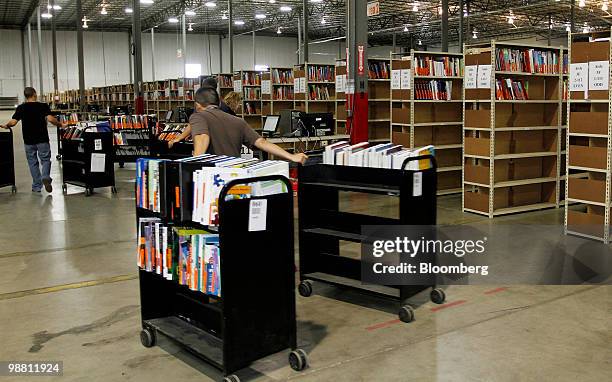 Employees restock returned textbooks at the Chegg Inc. Warehouse in Shepherdsville, Kentucky, U.S., on Thursday, April 29, 2010. No more $120...