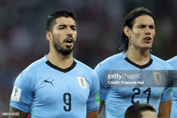Luis Suarez of Uruguay and Edinson Cavani of Uruguay sing the national anthem prior to the 2018 FIFA World Cup Russia Round of 16 match between...