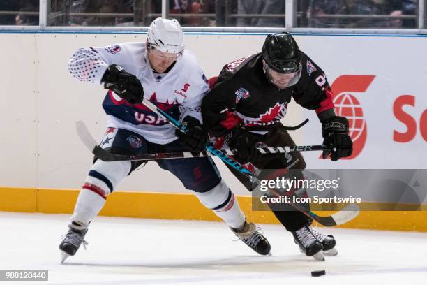 Player Eddie Gale and Canada Player David Rutherford come together at the 2018 Ice Hockey Classic between USA and Canada at Qudos Bank Arena on June...