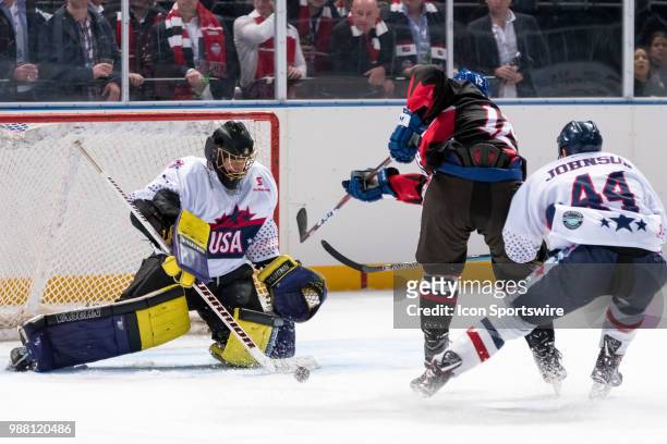 Canada Player Kyle Baun has a shot but it's saved by USA player Michael Clemente at the 2018 Ice Hockey Classic between USA and Canada at Qudos Bank...