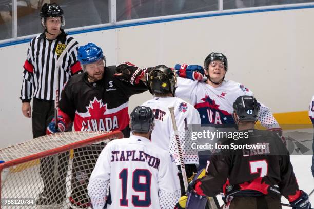 Canada Player Eric Neilson grabs the jersey of USA player Jesse Craige at the 2018 Ice Hockey Classic between USA and Canada at Qudos Bank Arena on...