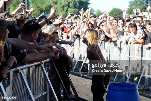 Iggy Pop supports Queens of the Stone Age on stage at Finsbury Park on June 30, 2018 in London, England.