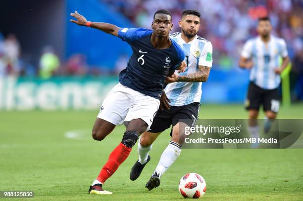 Ever Banega of Argentina tackles Paul Pogba of France during the 2018 FIFA World Cup Russia Round of 16 match between France and Argentina at Kazan...