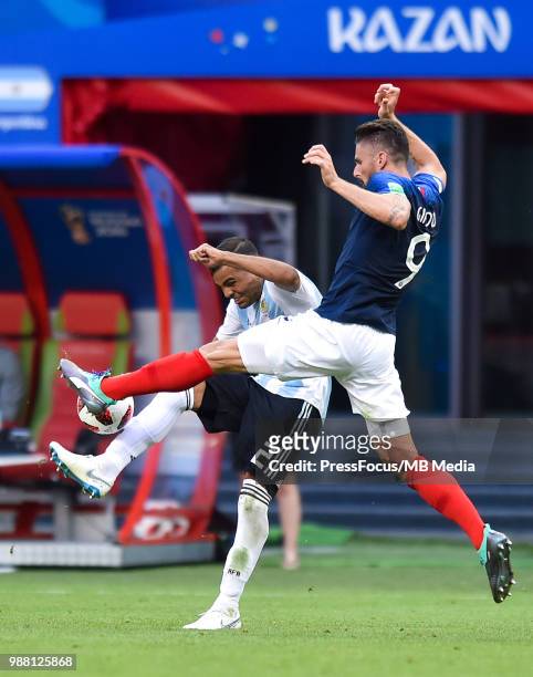 Olivier Giroud of France tackles Gabriel Mercado of Argentina during the 2018 FIFA World Cup Russia Round of 16 match between France and Argentina at...