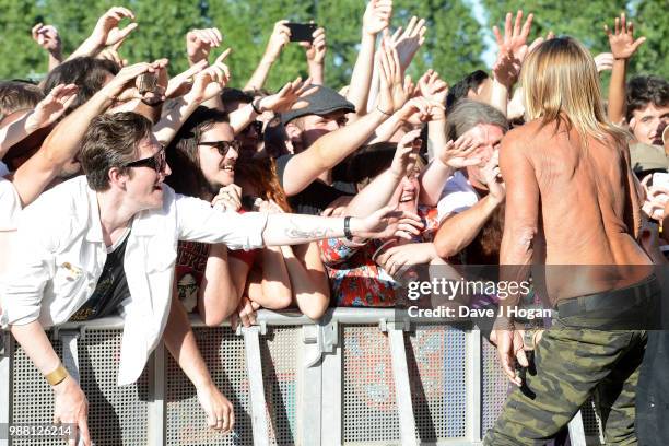 Iggy Pop supports Queens of the Stone Age on stage at Finsbury Park on June 30, 2018 in London, England.