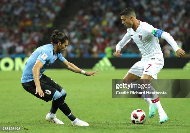 Jose Gimenez of Uruguay challenges Cristiano Ronaldo of Portugal during the 2018 FIFA World Cup Russia Round of 16 match between Uruguay and Portugal...