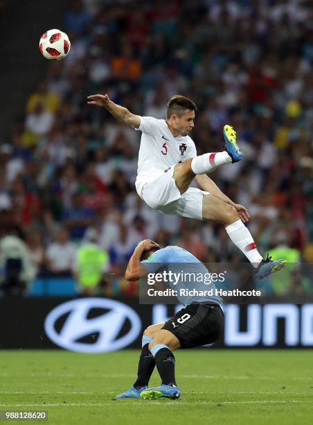 Raphael Guerreiro of Portugal and Luis Suarez of Uruguay clash during the 2018 FIFA World Cup Russia Round of 16 match between Uruguay and Portugal...