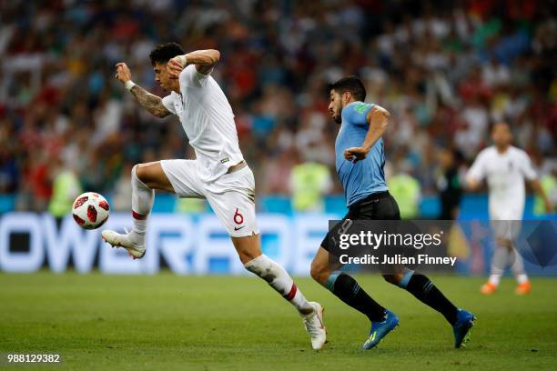 Jose Fonte of Portugal controls the ball under pressure from Luis Suarez of Uruguay during the 2018 FIFA World Cup Russia Round of 16 match between...