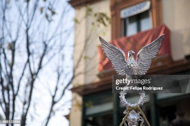 roman eagle from a brotherhood banner, holy week 2008, seville, spain - holy week banner stock pictures, royalty-free photos & images