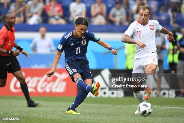 Takashi Usami of Japan and Kamil Grosicki of Poland compete for the ball during the 2018 FIFA World Cup Russia group H match between Japan and Poland...
