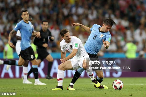 Adrien Silva of Portugal is challenged by Rodrigo Bentancur of Uruguay during the 2018 FIFA World Cup Russia Round of 16 match between Uruguay and...