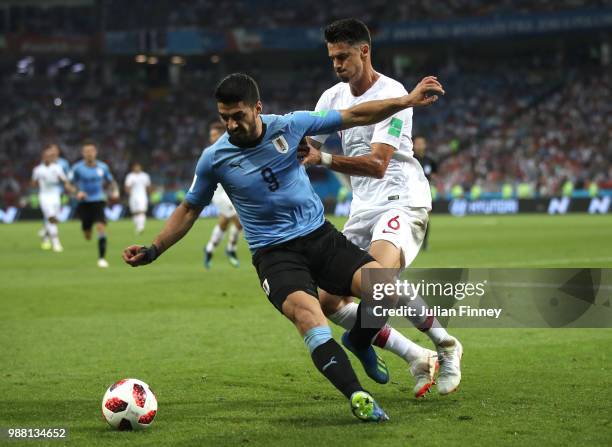 Luis Suarez of Uruguay is challenged by Jose Fonte of Portugal during the 2018 FIFA World Cup Russia Round of 16 match between Uruguay and Portugal...