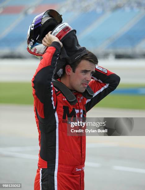 Timmy Hill, driver of the OCR Gaz Bar Toyota, walks to his car during qualifying for the NASCAR Xfinity Series Overton's 300 at Chicagoland Speedway...