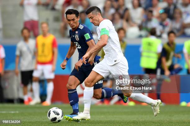 Robert Lewandowski of Poland and Tomoaki Makino of Japan compete for the ball during the 2018 FIFA World Cup Russia group H match between Japan and...