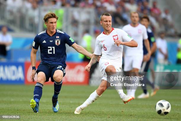 Jacek Goralski of Poland and Gotoku Sakai of Japan compete for the ball during the 2018 FIFA World Cup Russia group H match between Japan and Poland...