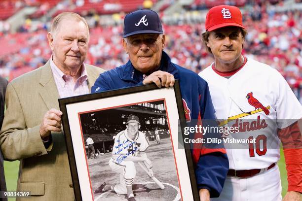 Former St. Louis Cardinals player Red Schoendienst and manager Tony LaRussa of the St. Louis Cardinals present a signed photo to Bobby Cox of the...