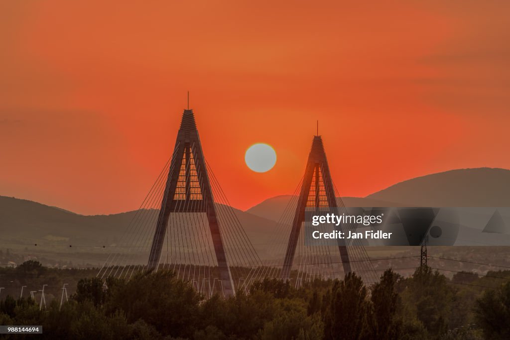 Sunset on a modern bridge, industrial view