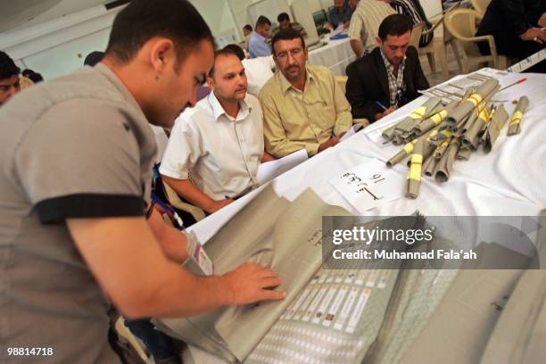 An Iraqi electoral worker counts ballots of Parliamentary elections as observers from politcial parties watch on May 3, 2010 in Baghdad, Iraq. The...