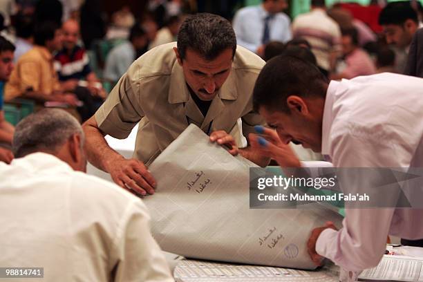 Iraqi electoral workers count ballots from the recent parliamentary elections on May 3, 2010 in Baghdad, Iraq. The Iraqi Independent High Electoral...