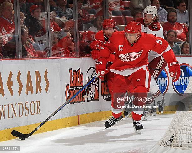 Nicklas Lidstrom of the Detroit Red Wings skates with the puck behind the net during Game Four of the Eastern Conference Quarterfinals of the 2010...