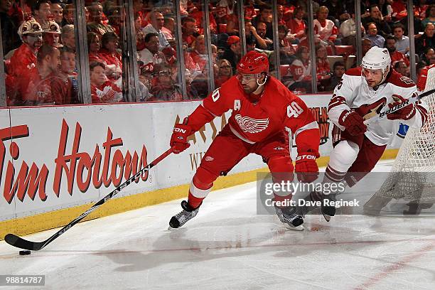 Henrik Zetterberg of the Detroit Red Wings protects the puck from Matthew Lombardi of the Phoenix Coyotes during Game Four of the Eastern Conference...