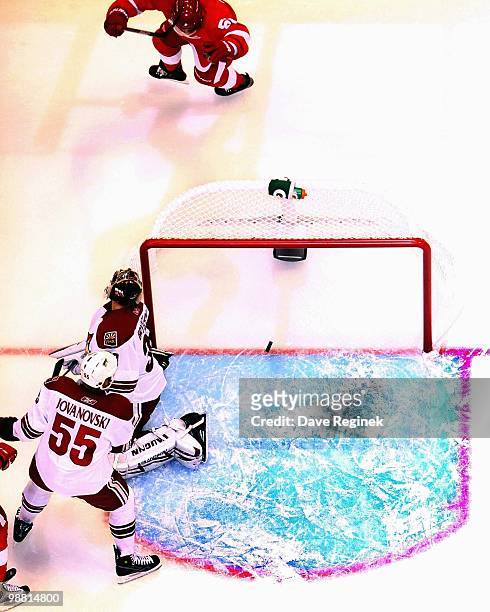 Ilya Bryzgalov of the Phoenix Coyotes and teammate Ed Jovanovski look back at the puck during Game Four of the Eastern Conference Quarterfinals of...