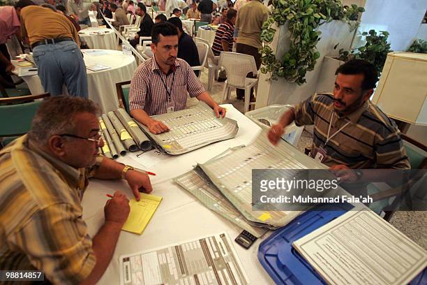 An Iraqi electoral worker counts ballots from the recent parliamentary elections on May 3, 2010 in Baghdad, Iraq. The Iraqi Independent High...