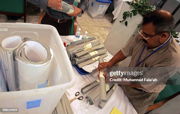 An Iraqi electoral worker counts ballots from the recent parliamentary elections on May 3, 2010 in Baghdad, Iraq. The Iraqi Independent High...