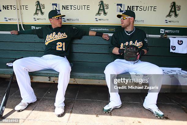 Ryan Sweeney and Daric Barton of the Oakland Athletics sitting in the dugout prior to the game against the New York Yankees at the Oakland Coliseum...