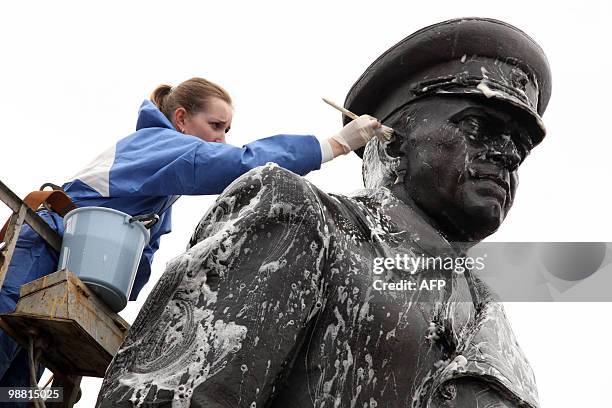 Municipal worker cleans a statue of Soviet WWII hero Marshall Georgy Zhukov in St. Petersburg on April 30, 2010. Russia will celebrate the 65th...