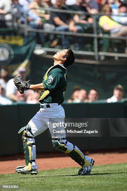 Kurt Suzuki of the Oakland Athletics chasing a pop-fly during the game against the New York Yankees at the Oakland Coliseum on April 22, 2010 in...